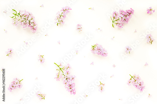 Flowers background. Lilac flowers on white wooden background. Top view, flat lay, copy space