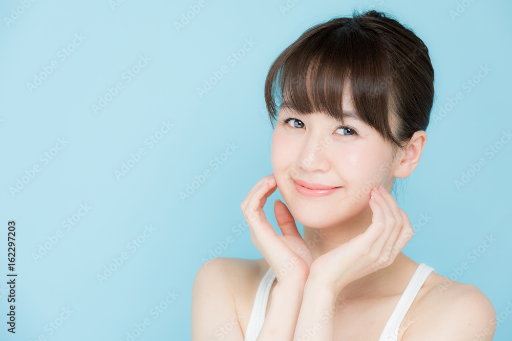 attractive asian woman beauty image on blue background attractive asian woman beauty image on blue background
