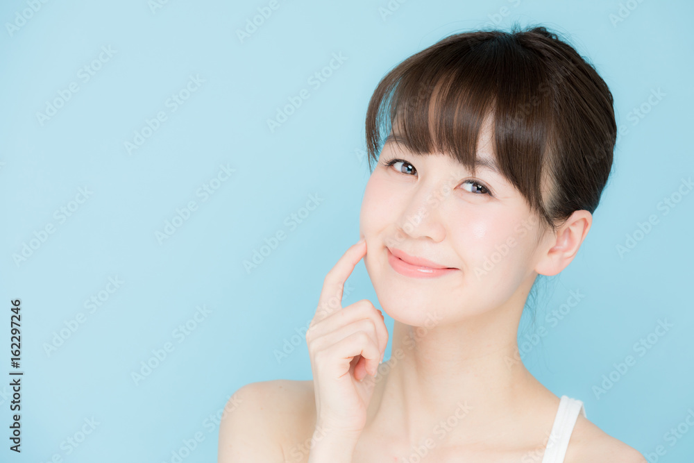 attractive asian woman beauty image on blue background attractive asian woman beauty image on blue background