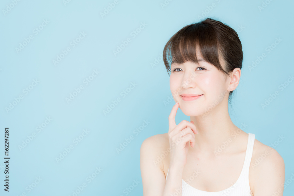 attractive asian woman beauty image on blue background attractive asian woman beauty image on blue background