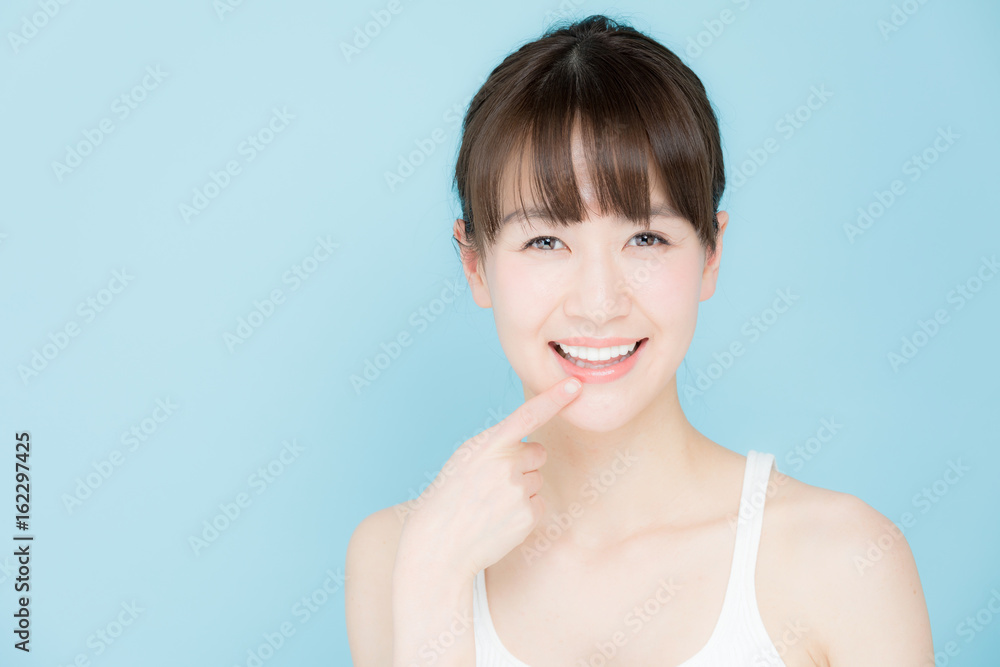 attractive asian woman beauty image on blue background attractive asian woman beauty image on blue background
