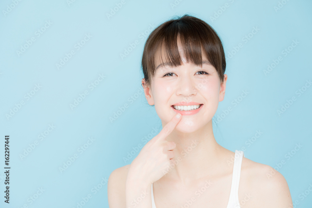 attractive asian woman beauty image on blue background attractive asian woman beauty image on blue background