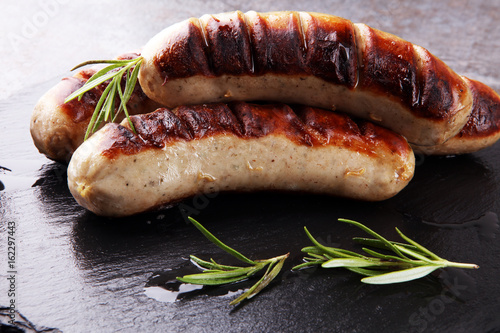 Grilled sausages with sauce ketchup on a wooden table - Home-made Pork Sausages