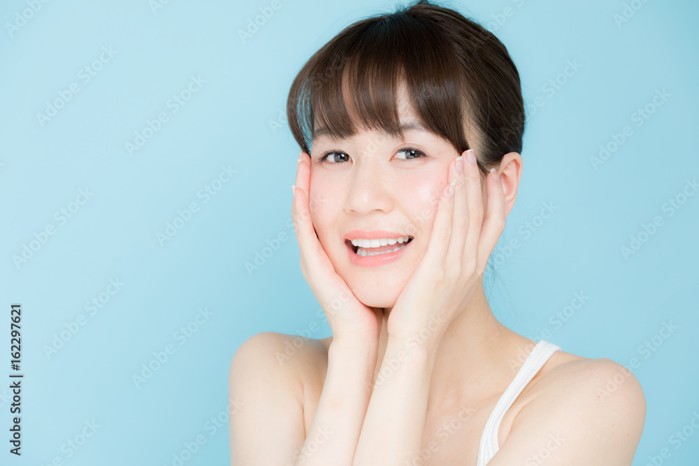 attractive asian woman beauty image on blue background attractive asian woman beauty image on blue background