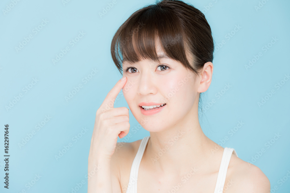 attractive asian woman beauty image on blue background attractive asian woman beauty image on blue background