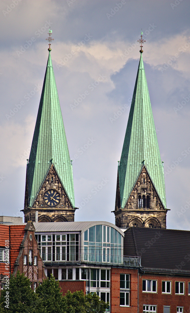 Two church spires over city skyline, Bremen, Germany