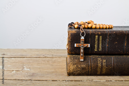 Rosary beads and books of Catholic Church liturgy photo