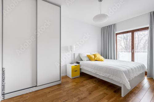 Bedroom with white wardrobe photo