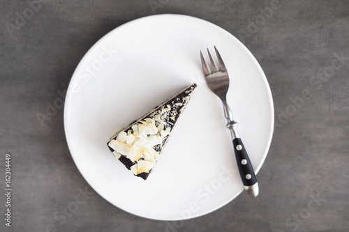 Healthy raw vegan chocolate coconut cake  from above on a gray background. Dark food photography.
