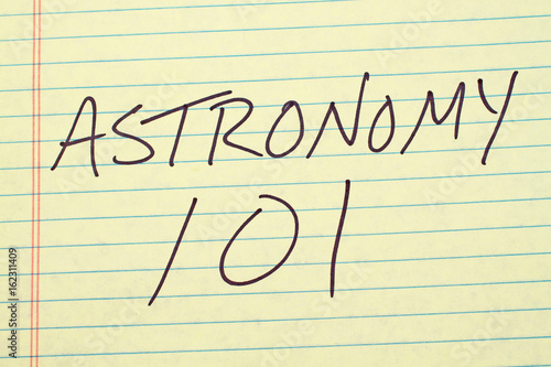 The words "Astronomy 101" on a yellow legal pad