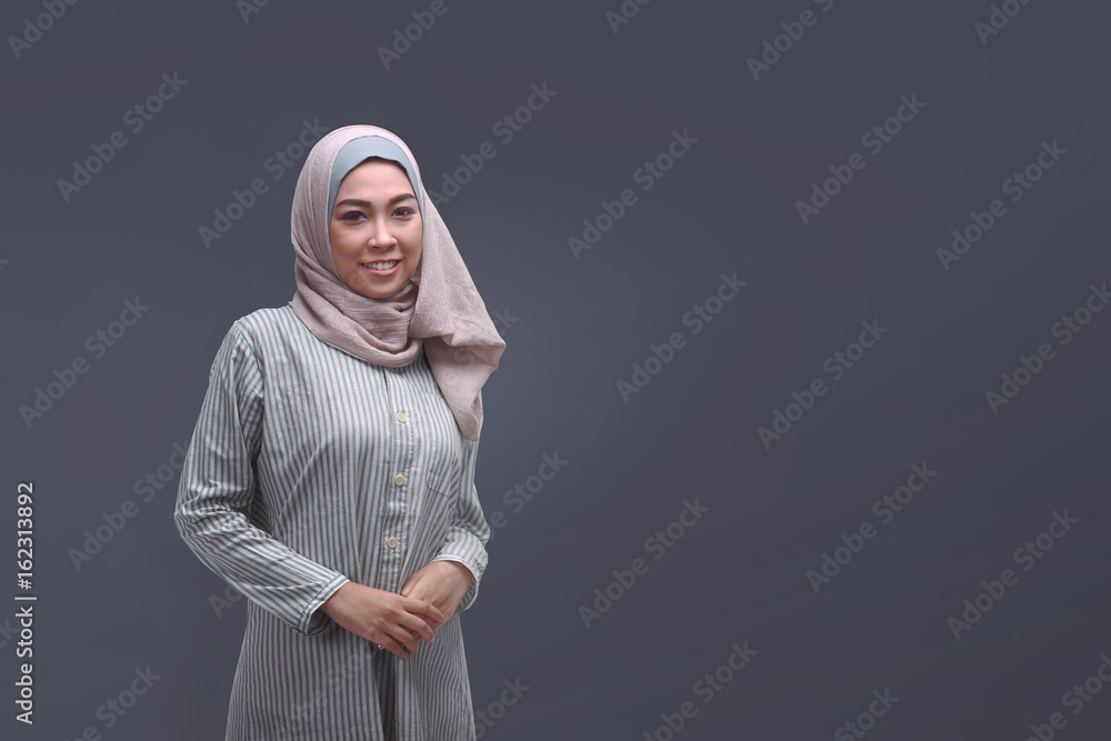 Beautiful asian muslim woman in hijab with relaxed pose Beautiful asian muslim woman in hijab with relaxed pose