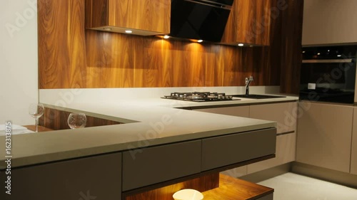 View of brown wood stylish washbasin in the kitchen in the modern style with wooden panel. photo