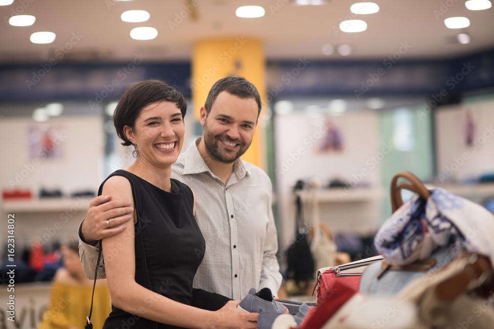 couple chooses shoes At Shoe Store