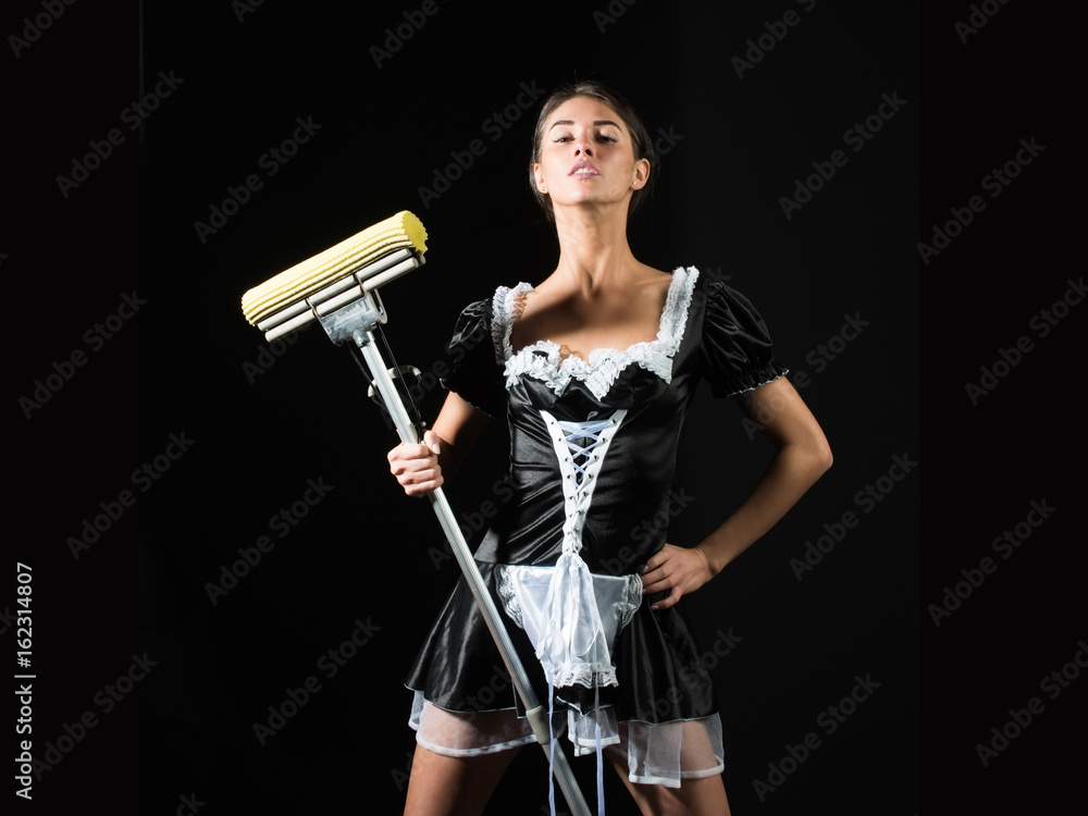pretty sexy girl or maid in uniform dancing with mop pretty sexy girl or maid in uniform dancing with mop