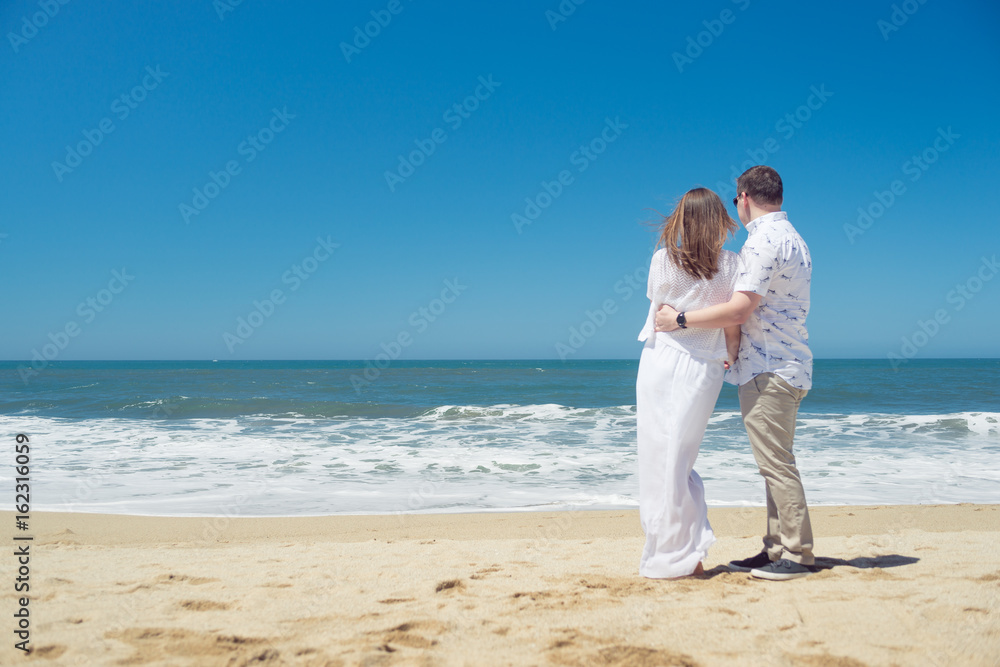 Young romantic couple hugging on the beach Young romantic couple hugging on the beach
