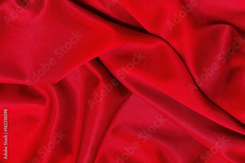 Red fabric pattern texture background, abstract background luxury cloth or liquid waves of grunge silk.