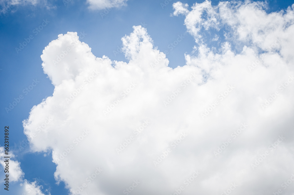 Obraz premium Looking up at big cloud blue sky