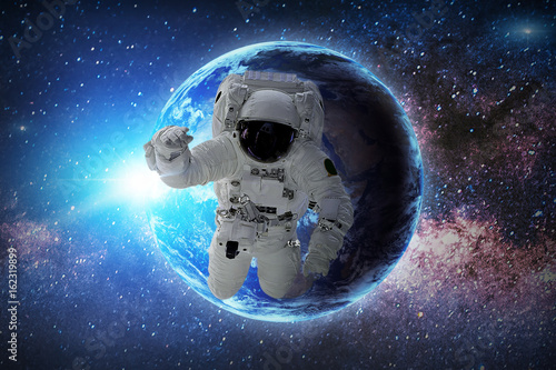 Astronaut in galaxy. Elements of this image furnished by NASA.