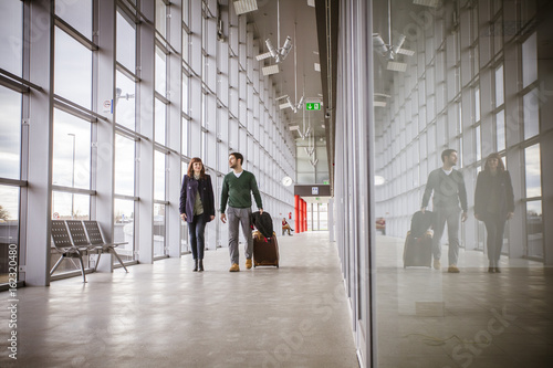 Young couple with lugggage in airport building