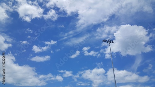 Beautiful blue sky with small spotlight stand alone on right side.