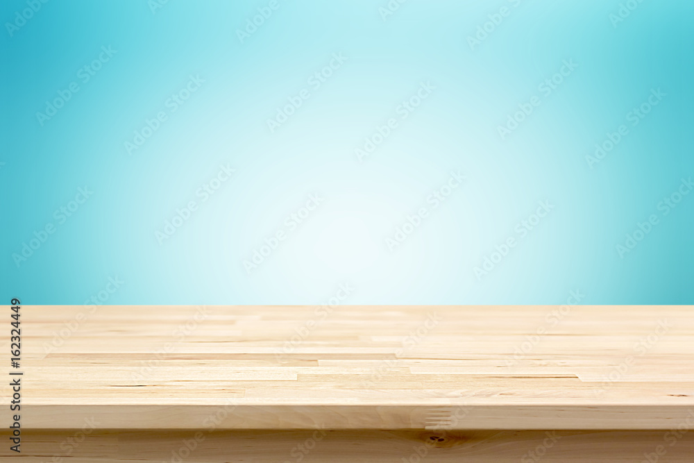 Wood table top on light blue gradient abstract  background