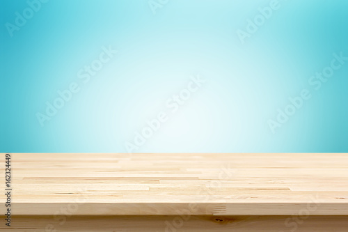 Wood table top on light blue gradient abstract background