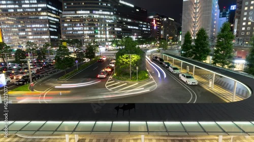 Time lapse of long exposure of taxi pool stop and illuminated building
