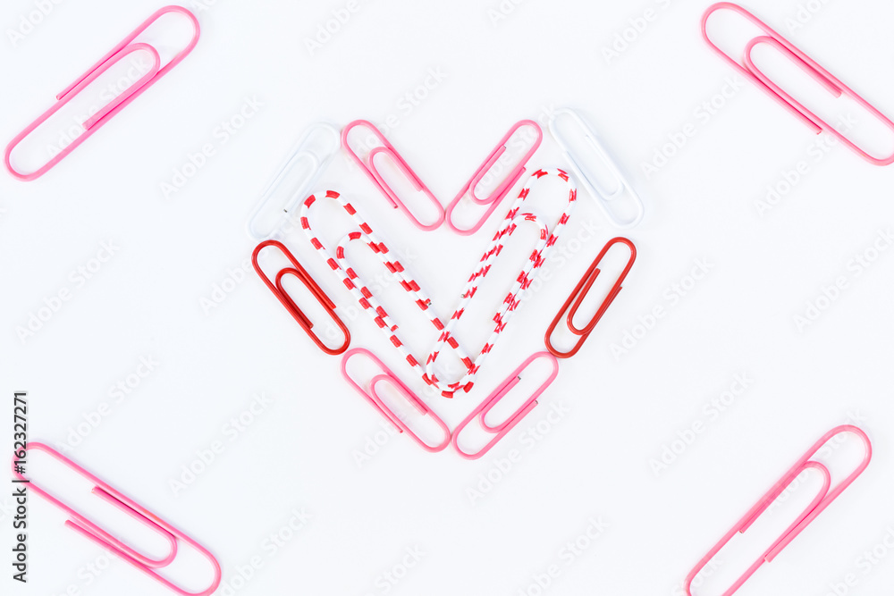 heart shape by paper clips on white background heart shape by paper clips on white background