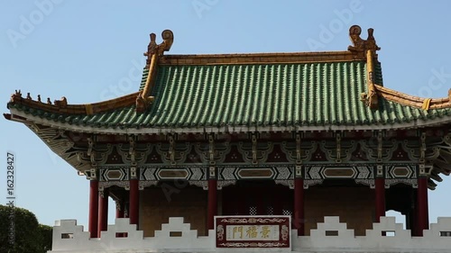 Top of the East Gate of Taipei in Taiwan. The gate also known as the Jingfu Gate or Dongmen. The sky is beautiful blue and cloudless. photo