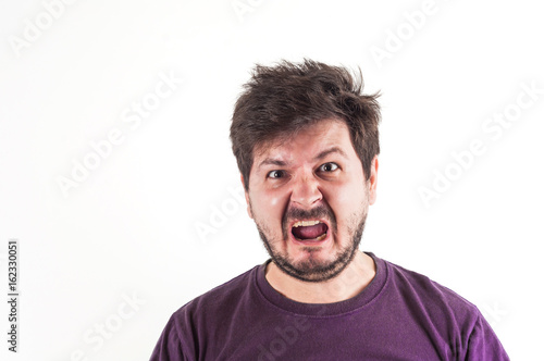 Screaming and angry face of 30 years old man in dark red t-shirt