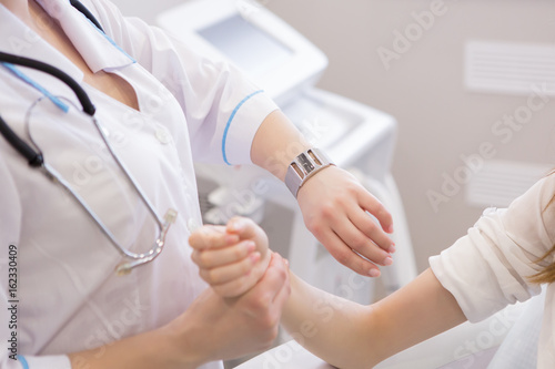 doctor measuring pulse of his senior patient. healthcare and medical concept © 4frame group