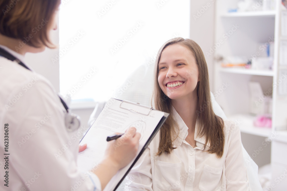 Female doctor explaining diagnosis to her female patient Female doctor explaining diagnosis to her female patient