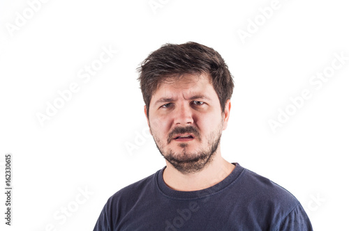 Man looking at camera with Misunderstanding face. Shock or disgust emotion about something in front