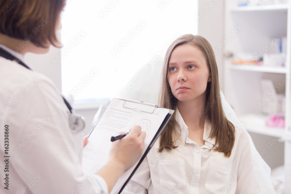 Female doctor explaining diagnosis to her female patient Female doctor explaining diagnosis to her female patient