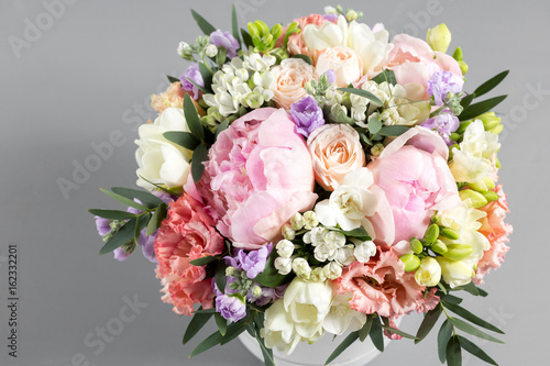luxurious and elegant bouquet of roses and Other flowers. Composition colors on gray background. Copy space. © malkovkosta