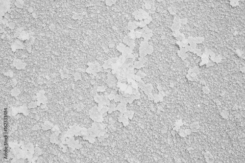 Natural salt texture on the coast of the lake. Abstract nature pattern of mineral salt for your white background.