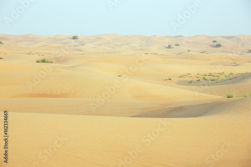 Shifting sand dunes with wind marks in the Dubai desert