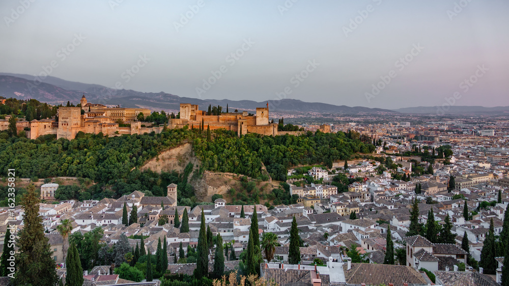 Arabic fortress of Alhambra and city at dusk, Spain.