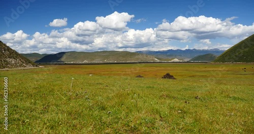 4k clouds mass rolling over mountains in Shangri-La yunnan,china.Napahai Wetland. photo