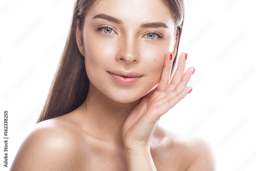 Beautiful young girl with a light natural make-up and perfect skin. Beauty face. Picture taken in the studio on a white background. Beautiful young girl with a light natural make-up and perfect skin. Beauty face. Picture taken in the studio on a white background.