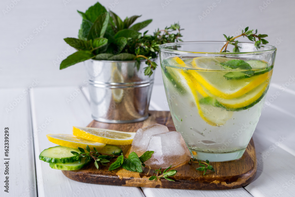 Fototapeta premium Refreshing cucumber cocktail, lemonade, detox water in a glasses on a white background. Summer drink.