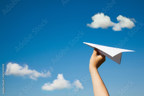Paper plane in child hand.