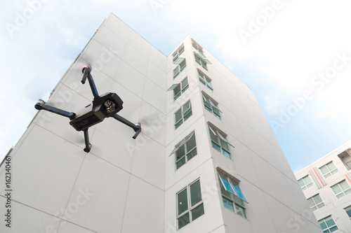 Drone flying over on building background.