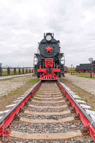 Old black steam locomotive on cloudy sky background. Nizhniy Novgorod, Russia. 
