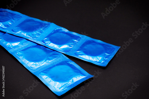 Condom black paper background. AIDS. Health. Contraception
