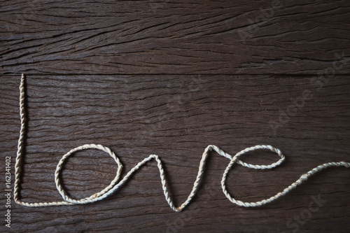 the word "Love" make with rope on wood background