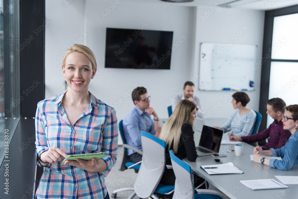 Pretty Businesswoman Using Tablet In Office Building by window Pretty Businesswoman Using Tablet In Office Building by window