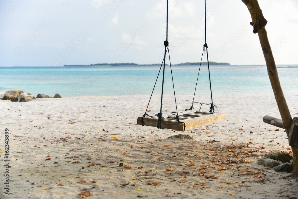 Swing hanging under the tree at Maafushi Island,Maldives Swing hanging under the tree at Maafushi Island,Maldives