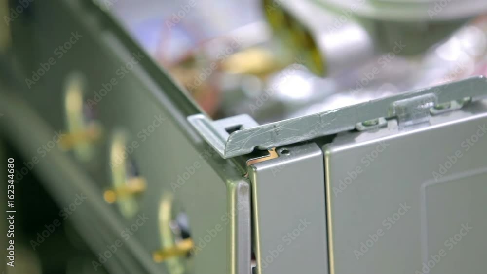 A worker is deconstructing the stove. He is taking out nails and panels and is using different tools. A worker is deconstructing the stove. He is taking out nails and panels and is using different tools.