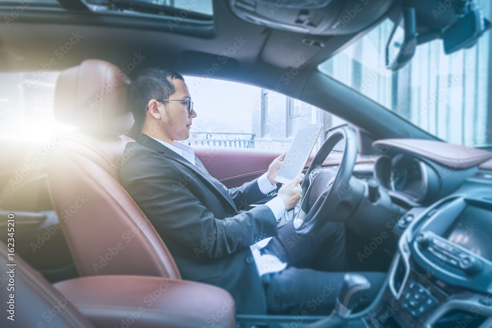 Businessman sit in his car using digital tablet. Businessman sit in his car using digital tablet.